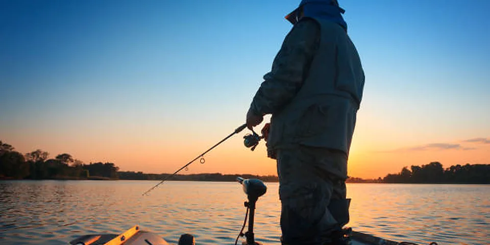Unbranded tackle setup on an empty dock beside a calm lake
