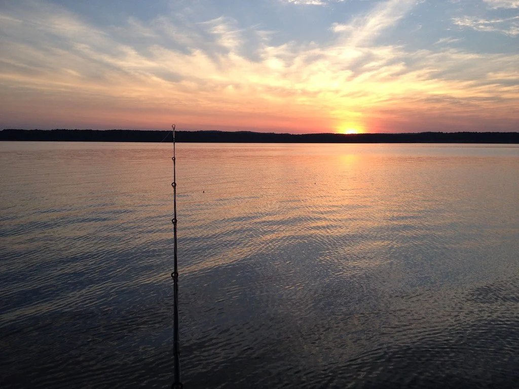 Angler fishing at Jordan Lake at sunset